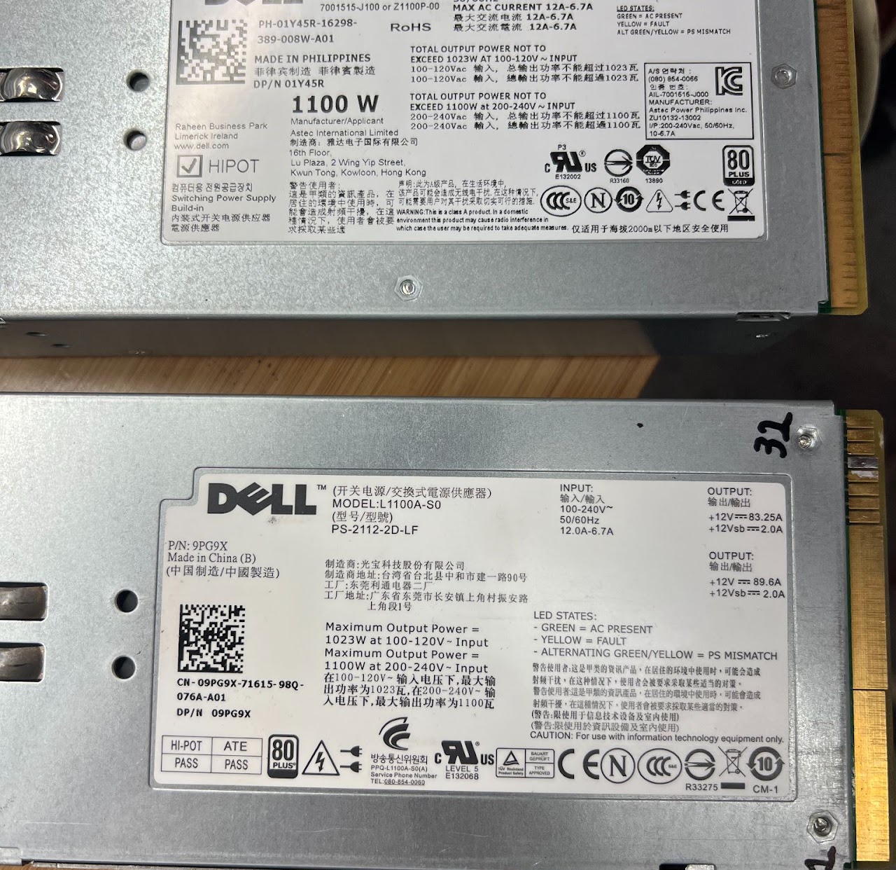 Labels on two Dell 1100W server power supplies
