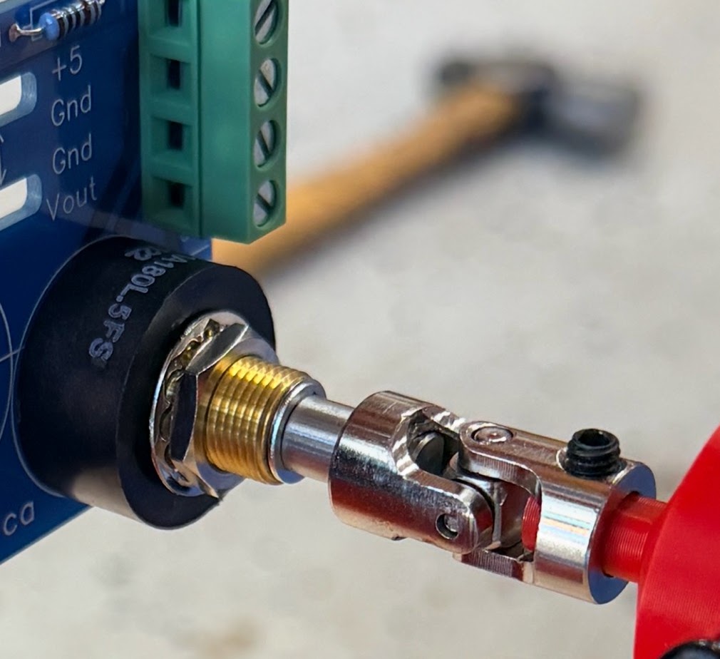 Universal joint installed between a position sensor and shaft